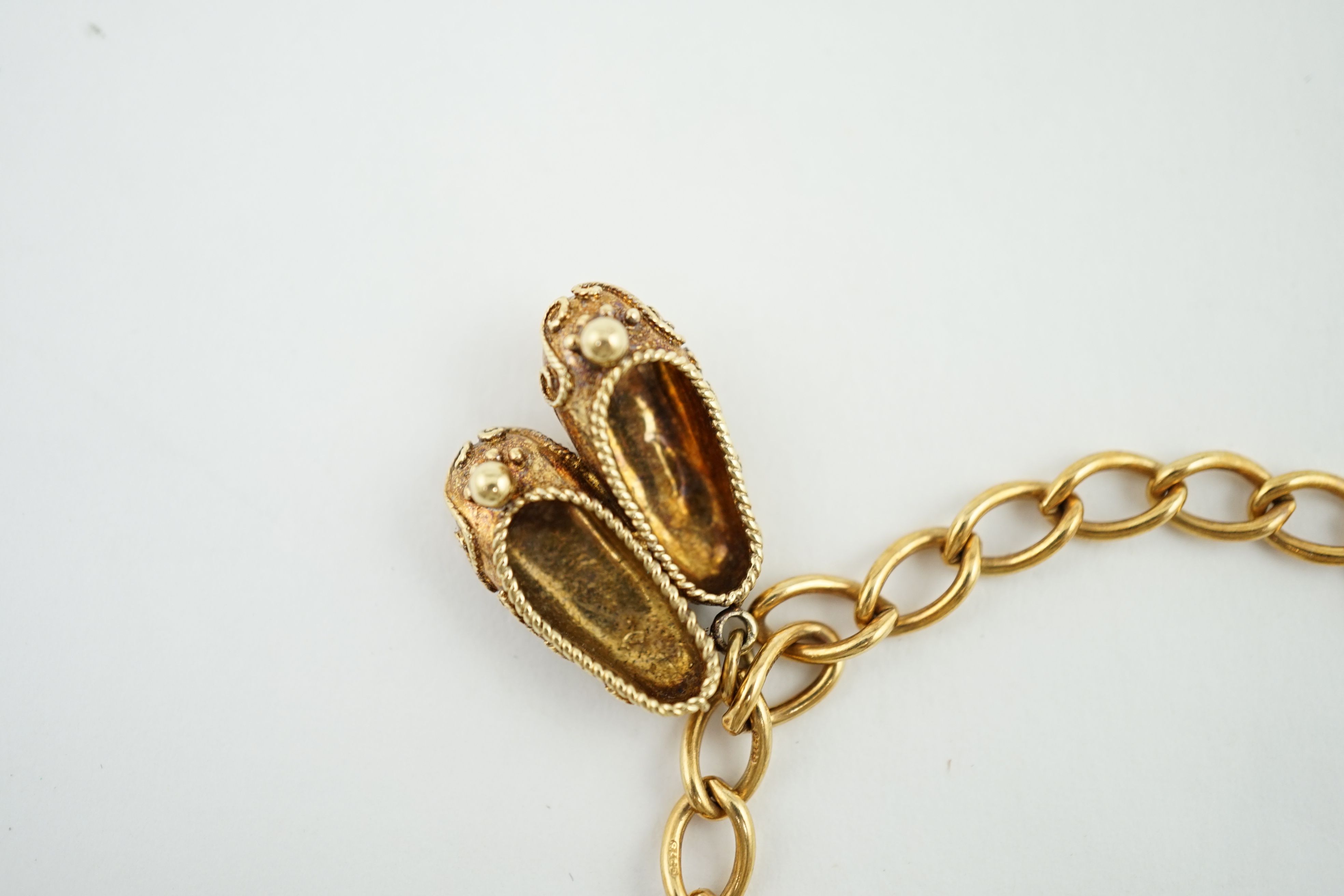 A 1960's 9ct gold oval link charm bracelet